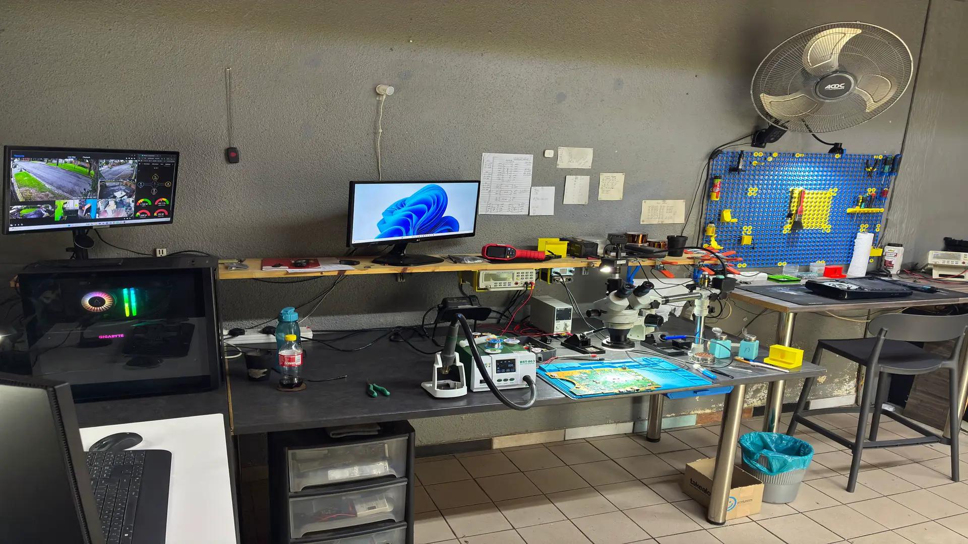 Console Service Centre repair workshop with monitors, microscope and soldering equipment